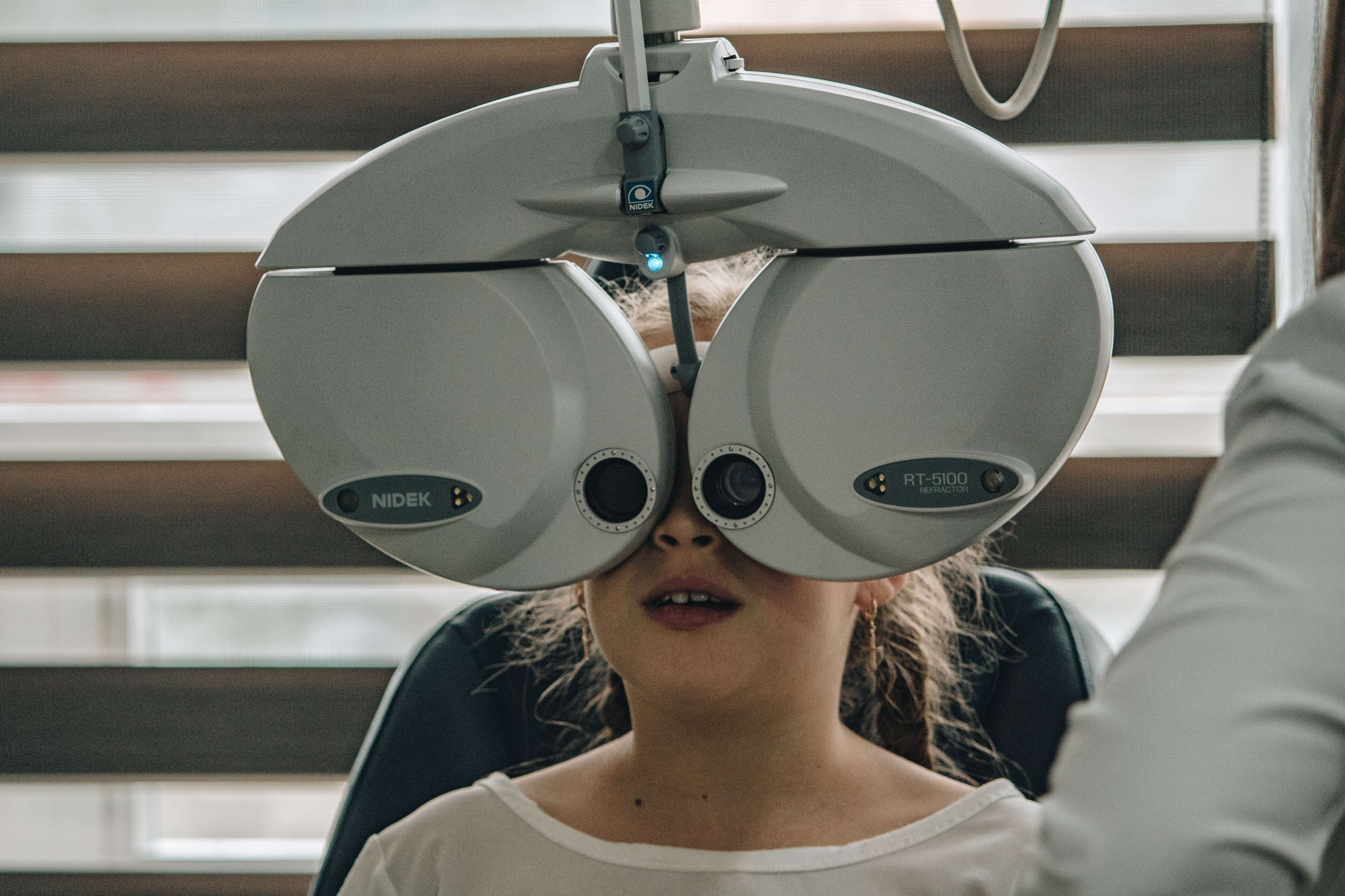 a child getting an eye exam from a doctor