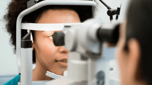 Image of young Black woman receiving eye care.
